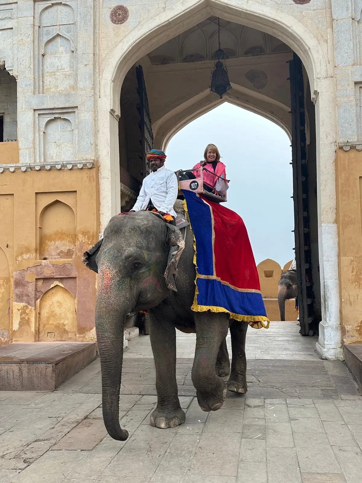 Person with marigold garland